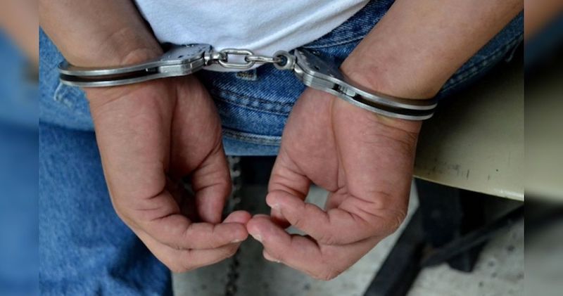 Detenido, esposado